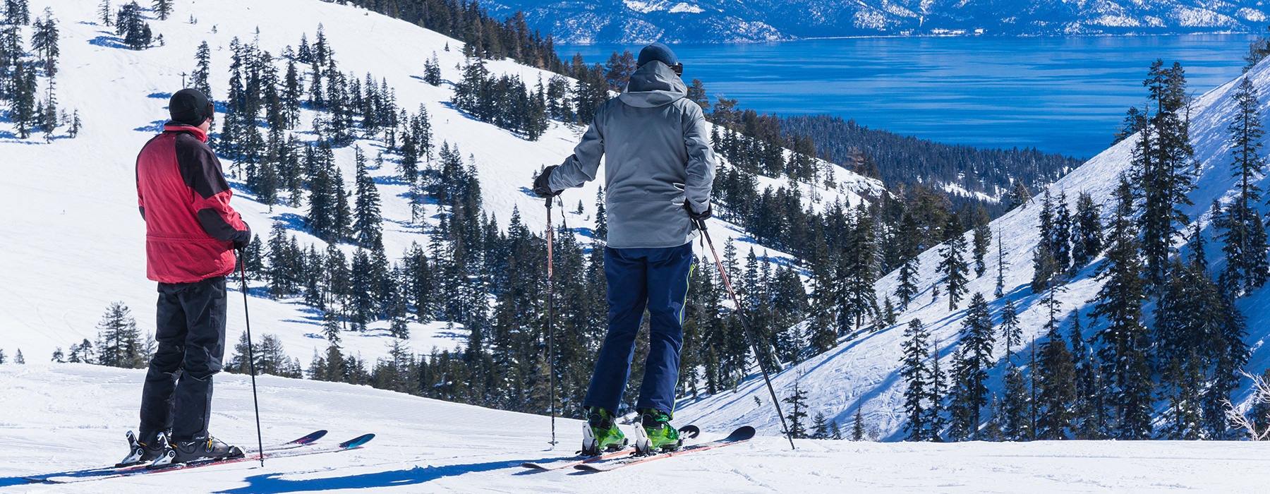 Couple out skiing on freshly powdered slopes