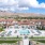 Luxury One Bedroom Apartments in Reno NV - Vida - Aerial View of the Pool, Grassy Lawns, and Building Exterior, and Lovely Hills in the Background